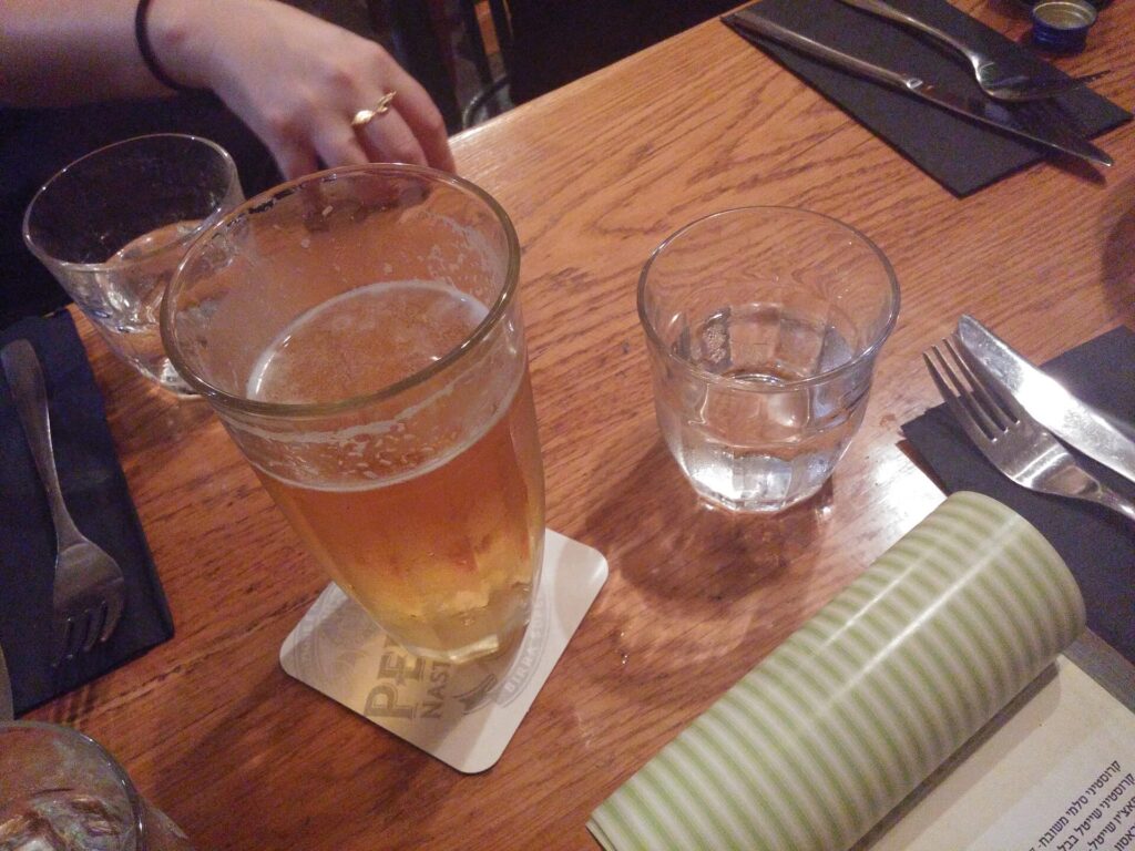 Glass of local craft beer on a wooden table